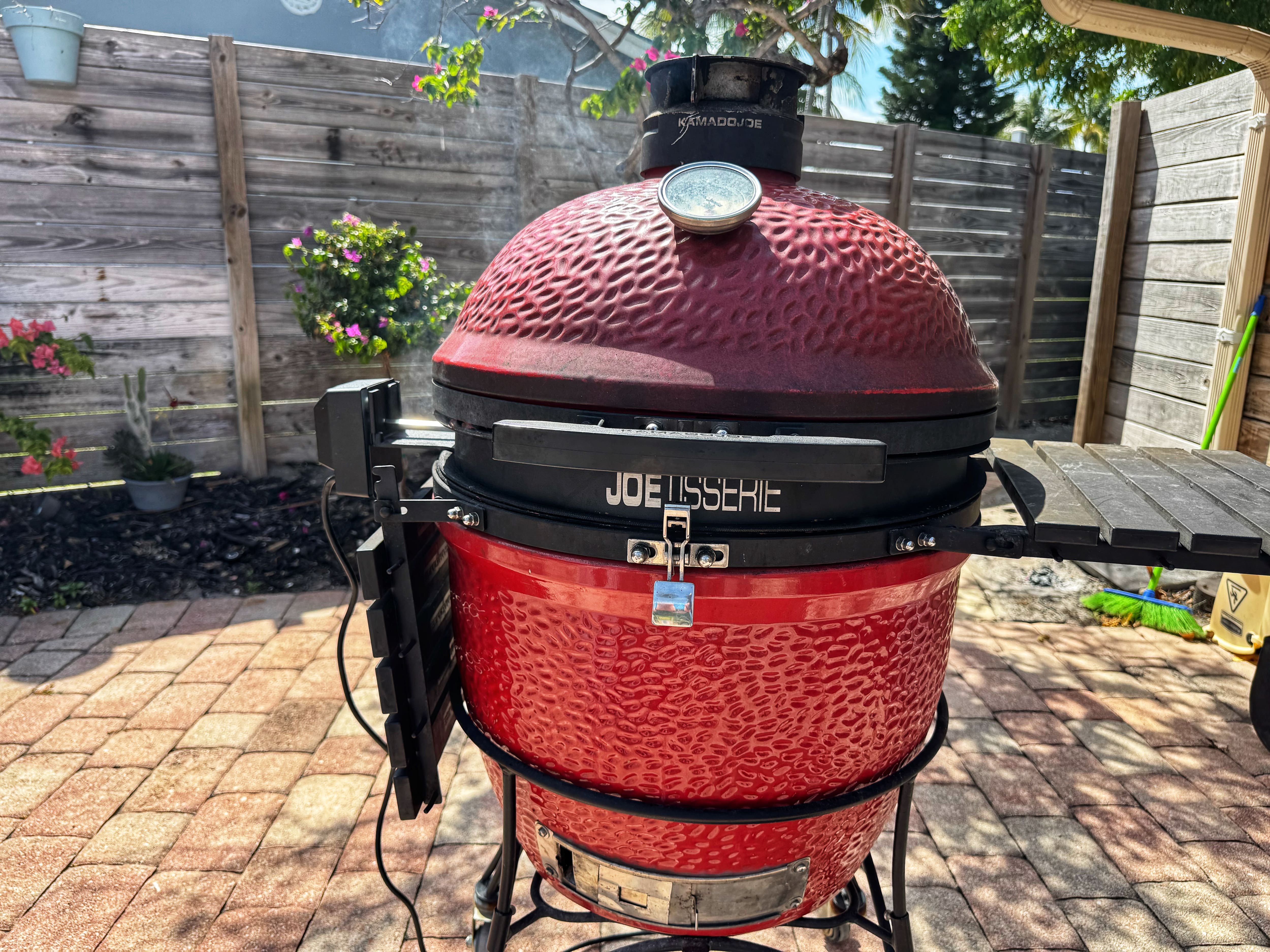 A red Kamado Joe Classic charcoal grill.