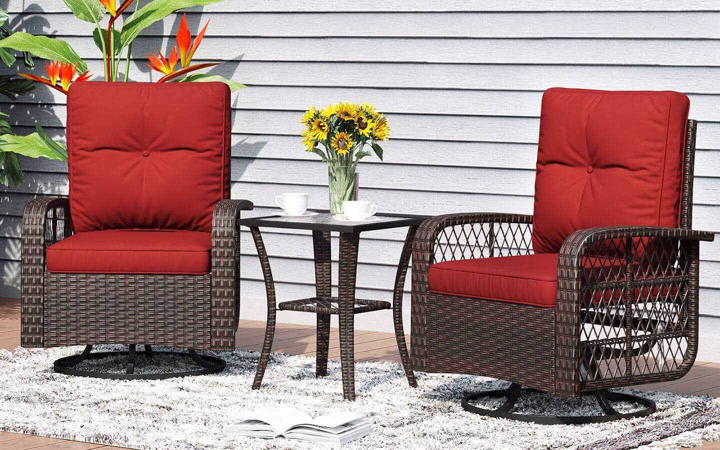 Two outdoor chairs on a sunny patio with a side table and a vase filled with flowers