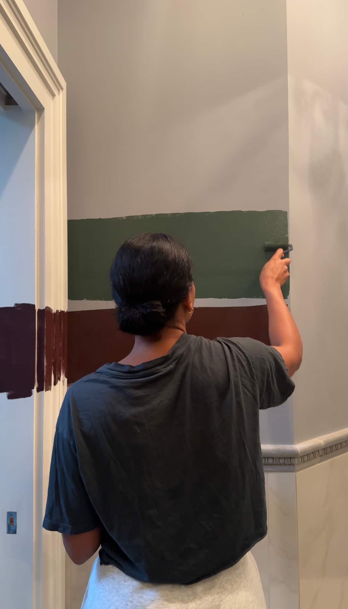 A person painting different colors on a wall.