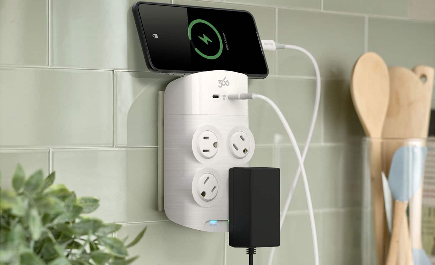 A rotating outlet charging a smart phone.