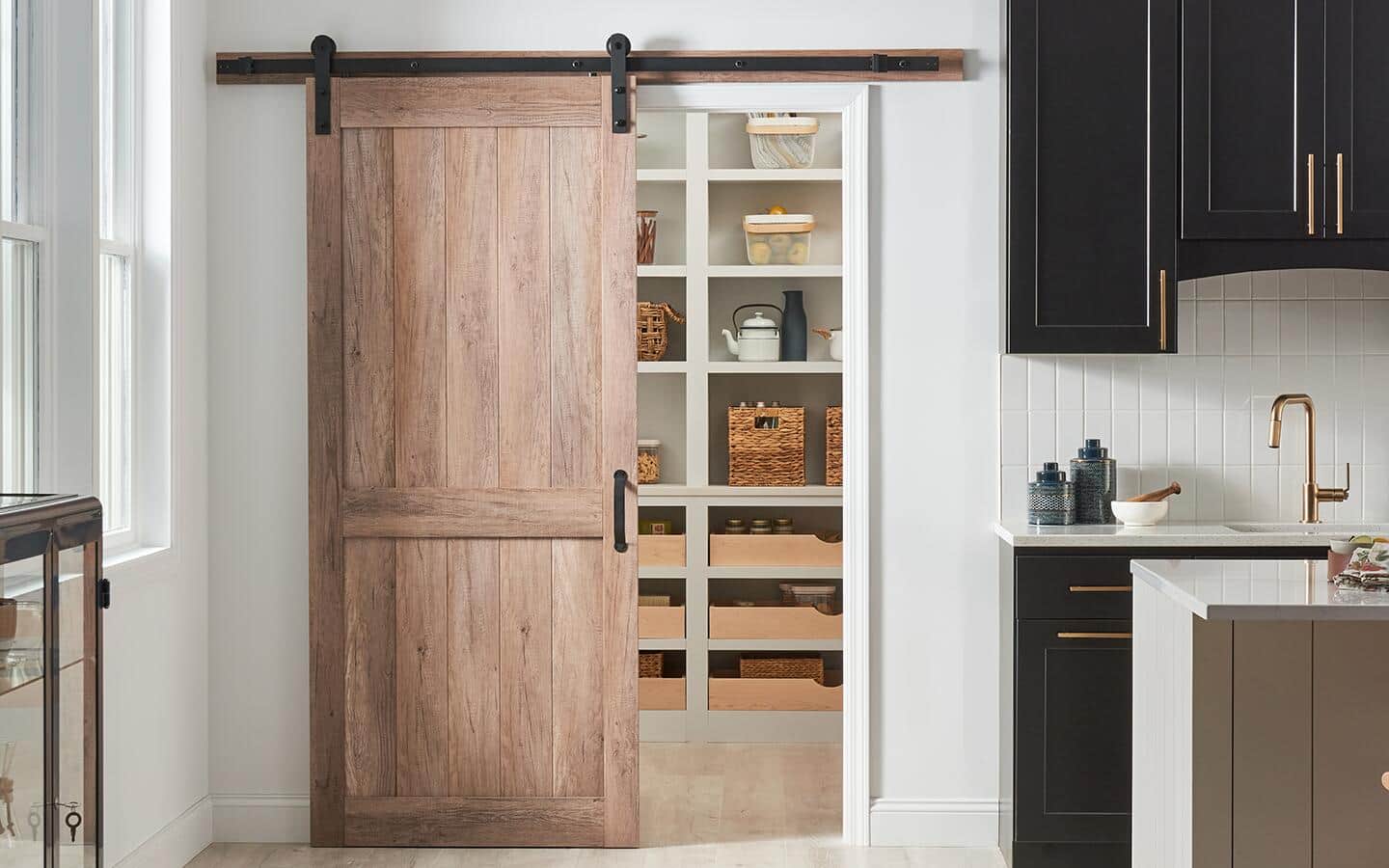 A stylish barn door installed on a pantry.