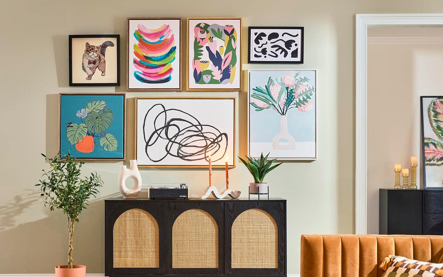 A variety of wall art adorns a living room wall A variety of wall art adorns a living room wall