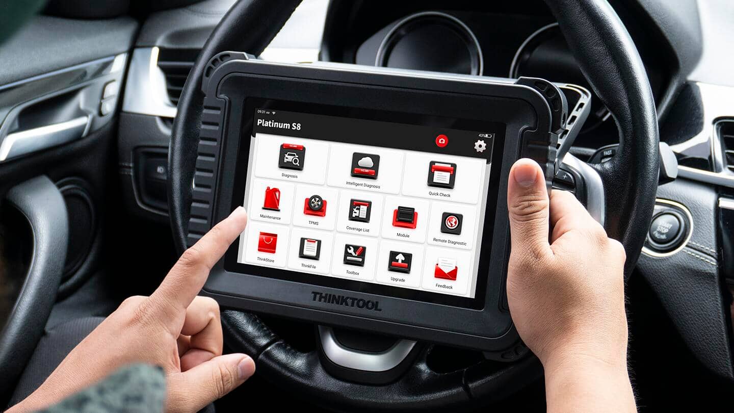 A person holds an OBD scanner. A person holds an OBD scanner.
