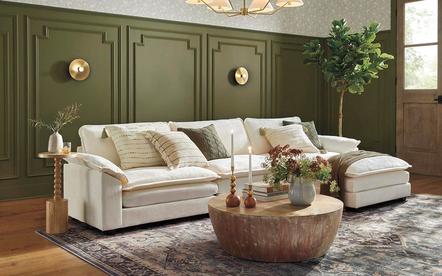 A classic living room featuring a paneled wall painted green.