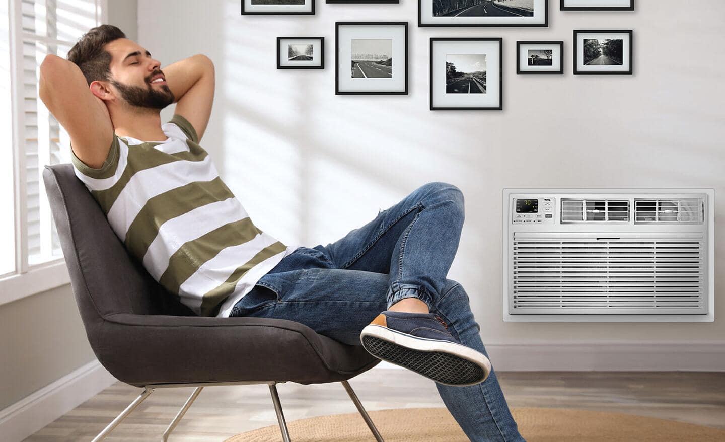 Someone sitting in a chair in front of a built-in air conditioner.