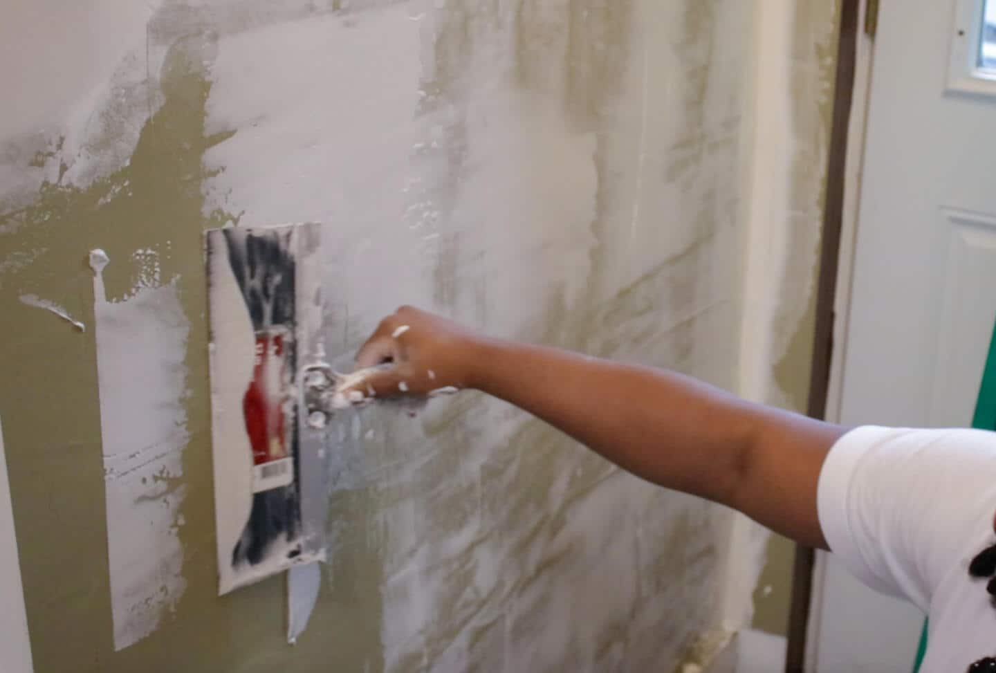 A person fixing a wall.