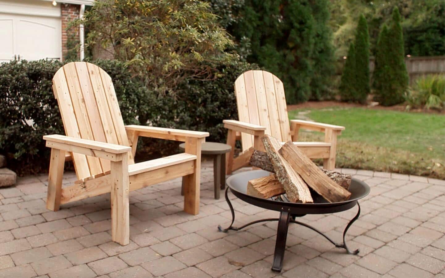 Two DIY Adirondack chairs outside near a fire pit. Two DIY Adirondack chairs outside near a fire pit.