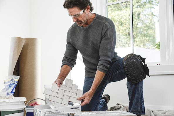 A Pro installs new flooring.