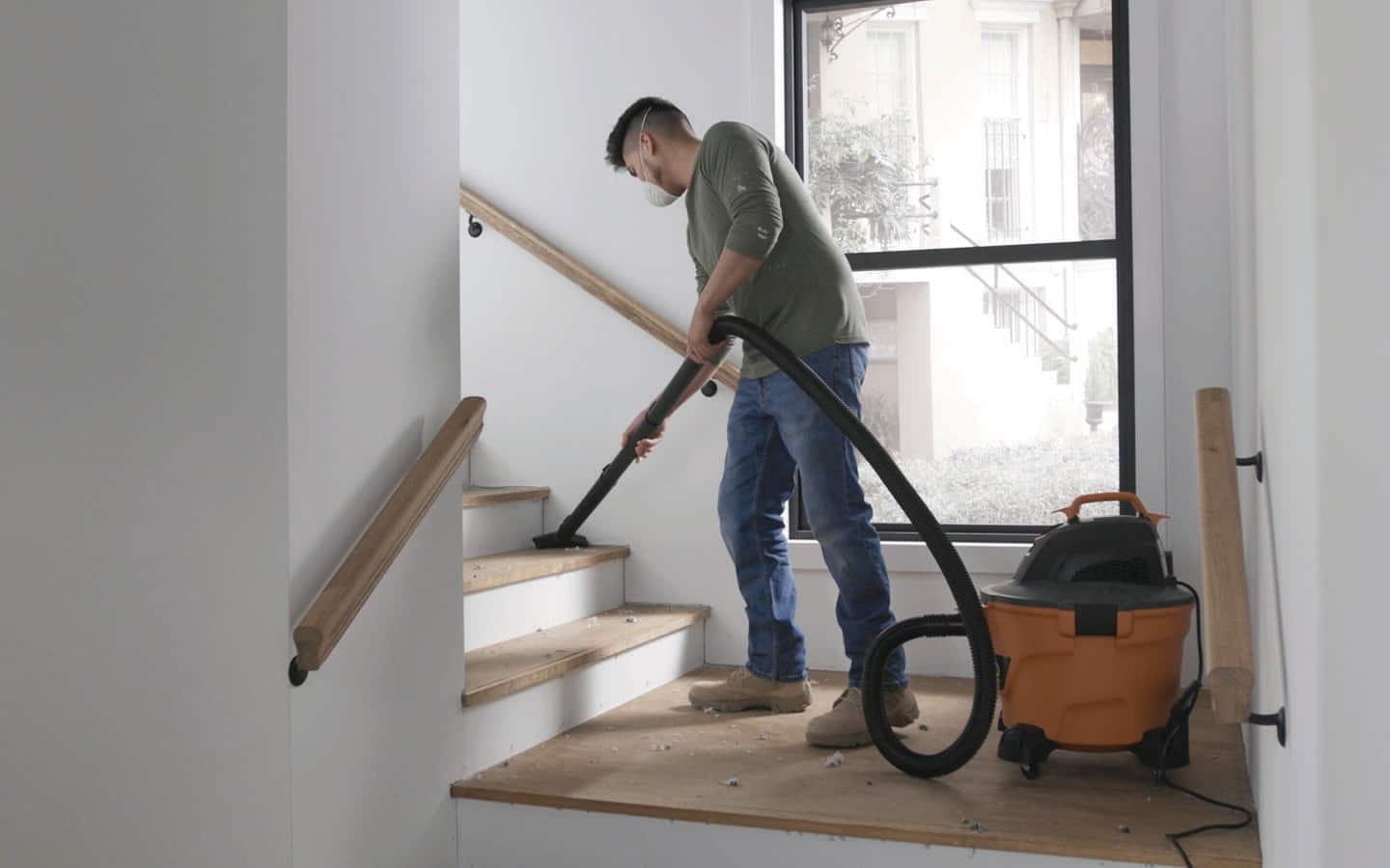 A person vacuuming stairs. A person vacuuming stairs.