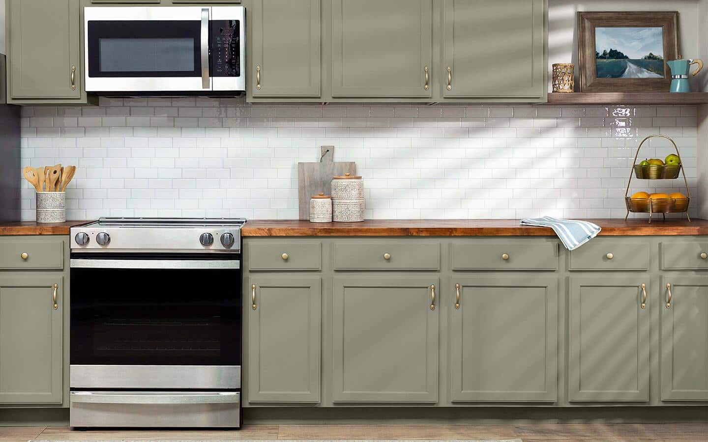 Upper and lower kitchen cabinets painted olive green surrounding a white backsplash. Upper and lower kitchen cabinets painted olive green surrounding a white backsplash.