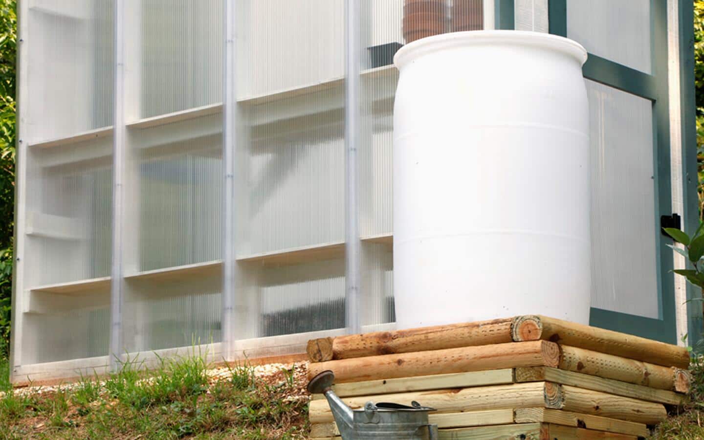 A rain barrel set up for a test fit outside in a garden space. A rain barrel set up for a test fit outside in a garden space.