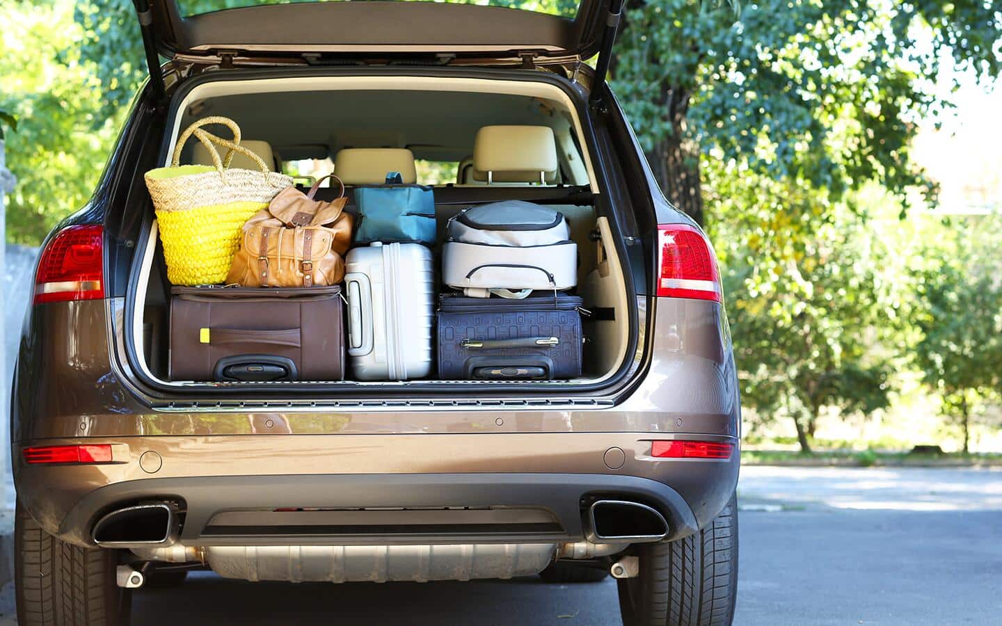 A car trunk hatchback packed with luggage and supplies. A car trunk hatchback packed with luggage and supplies.