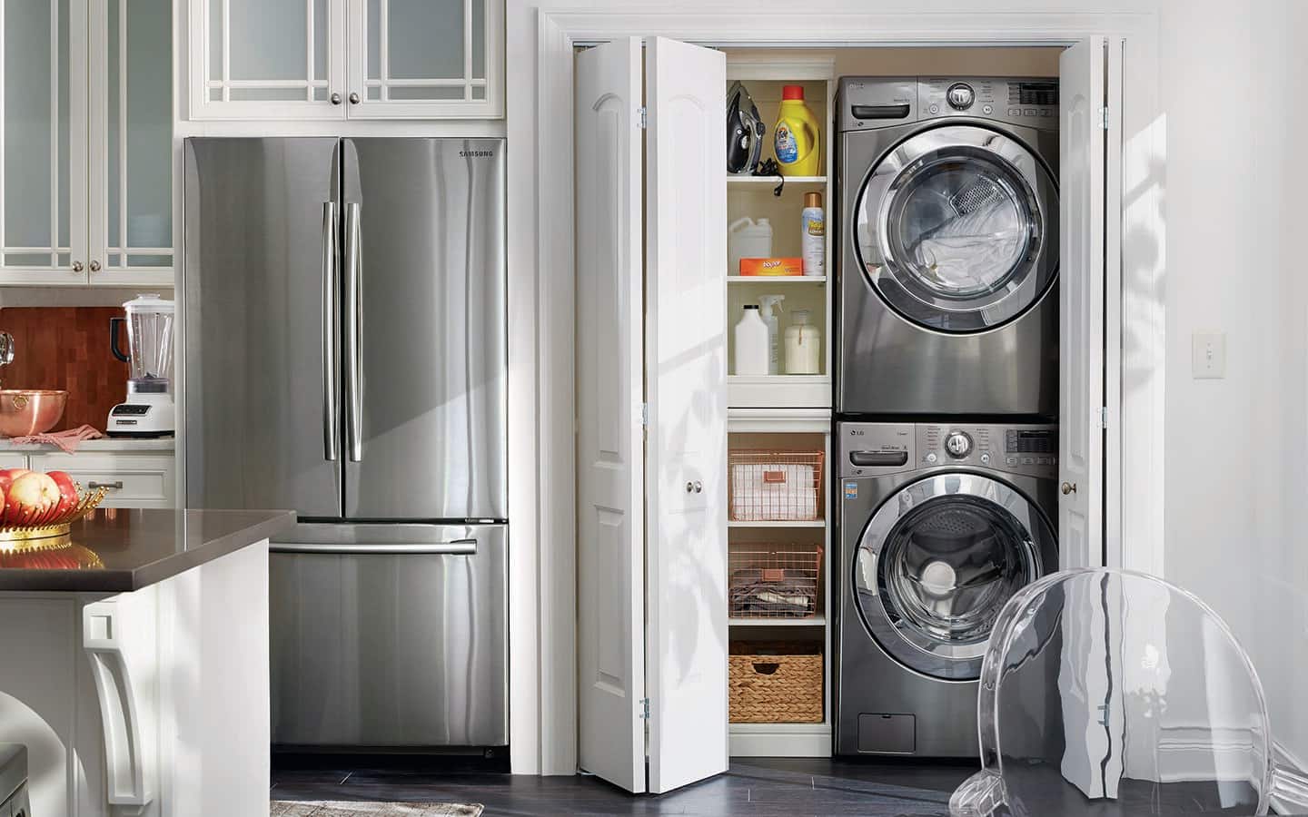 Bifold doors opened in a kitchen space showing a stacked washer dryer. Bifold doors opened in a kitchen space showing a stacked washer dryer.
