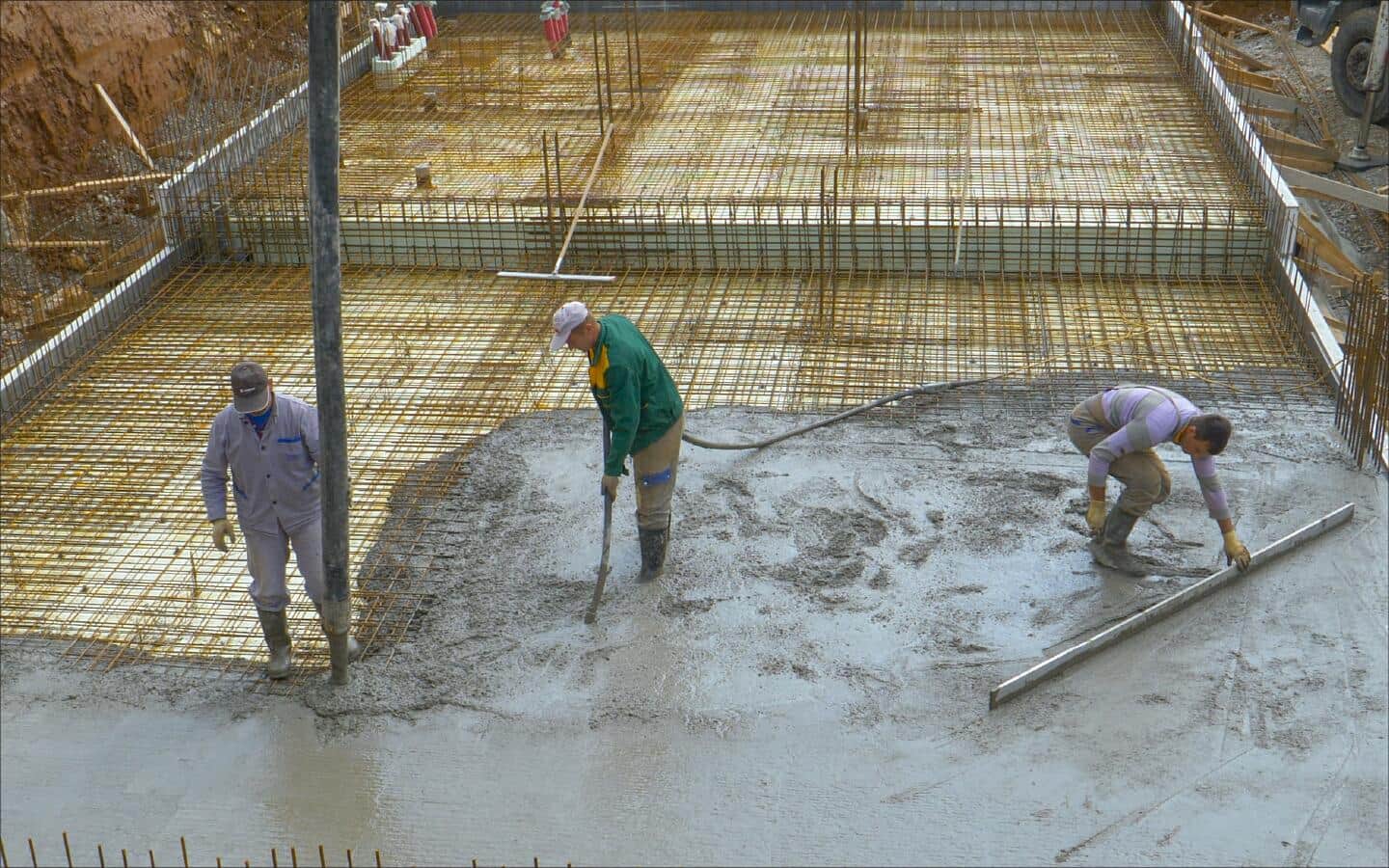 A concrete encasement is poured for conductors in a building. A concrete encasement is poured for conductors in a building.