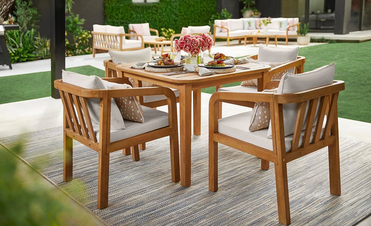 Wooden patio table and chairs set on a patio. 