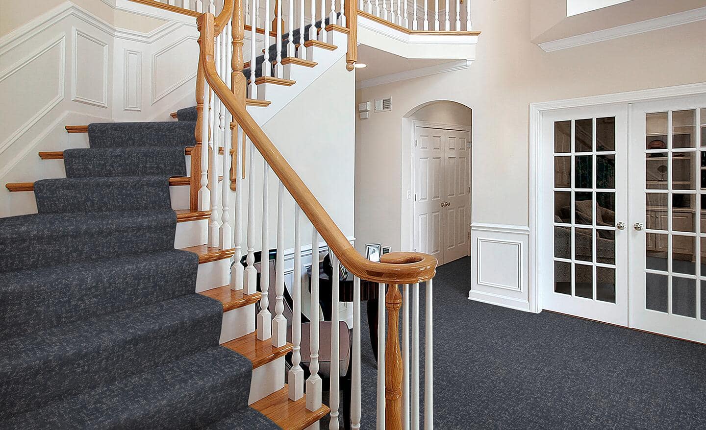 A blue stair runner installed on a flight of stairs.