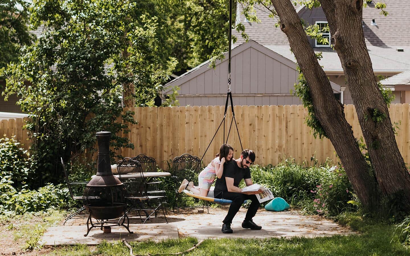 A family swinging in a tree swing.