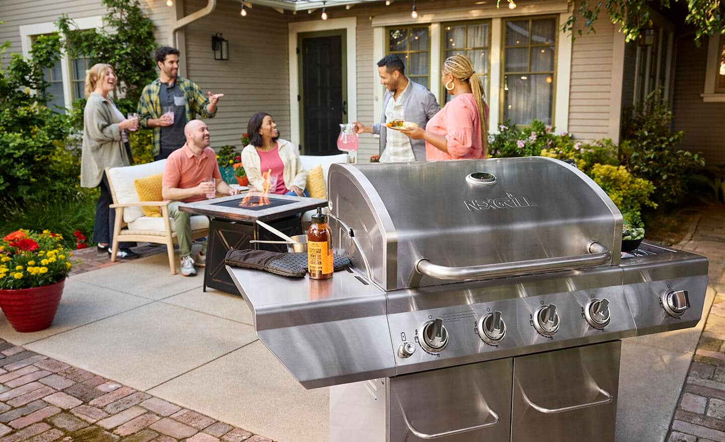 Friends enjoying a BBQ on a patio.