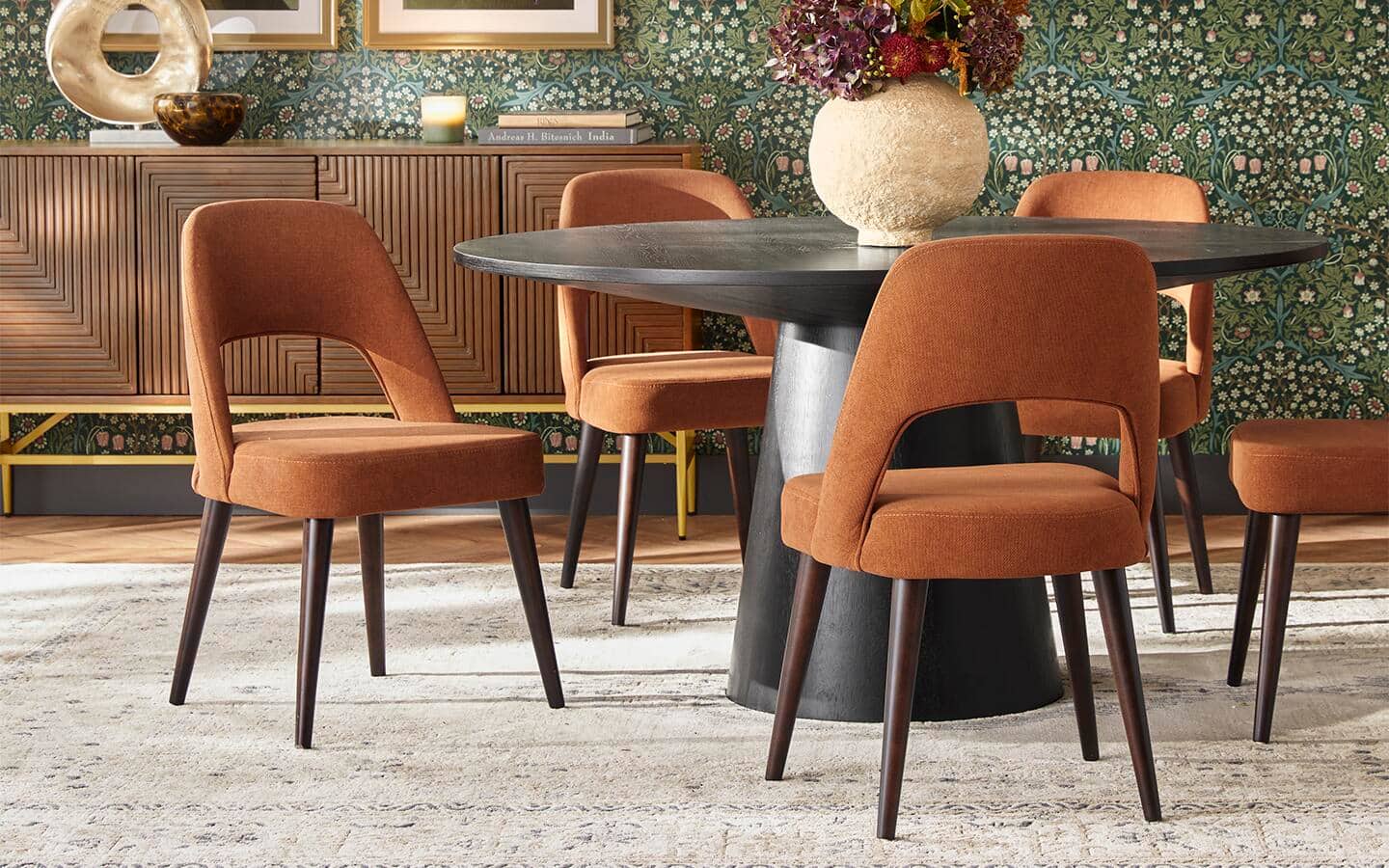 A modern dining room set placed on top of a vintage-style area rug.