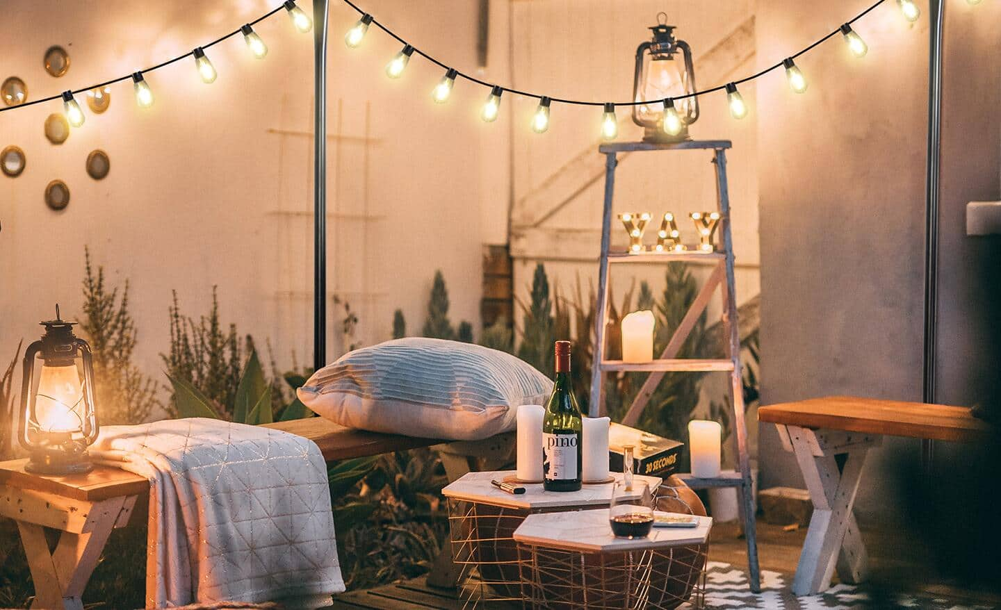 String lights illuminating a backyard patio