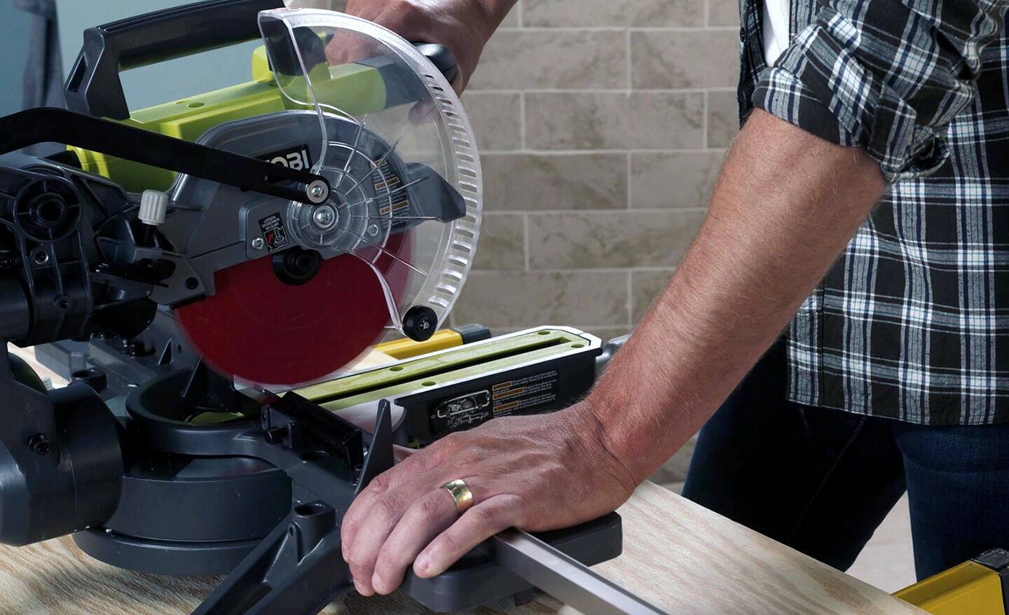 Man cutting threshold tack with a saw.