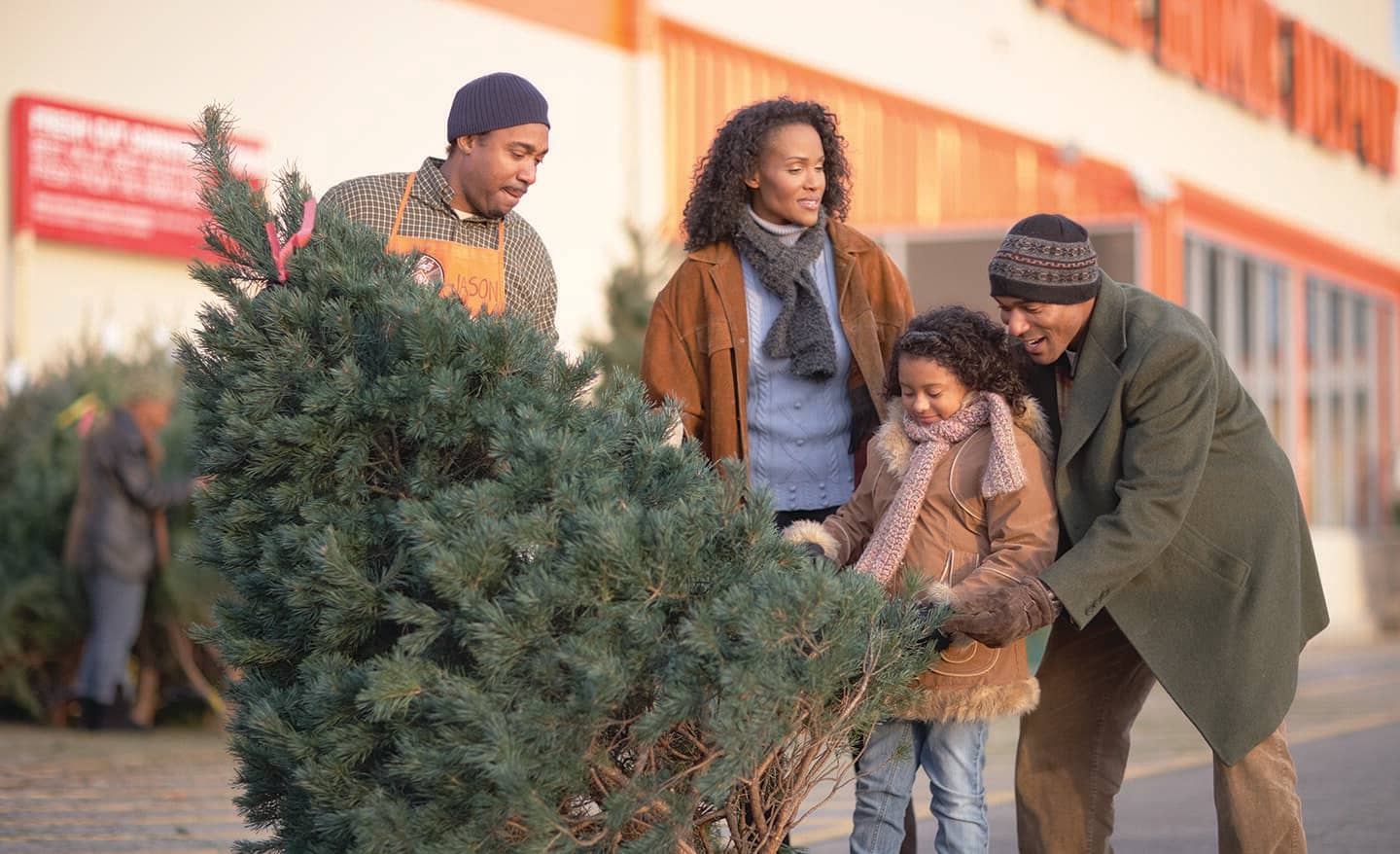 A THD representative helping a family considering a Scotch pine Christmas tree.