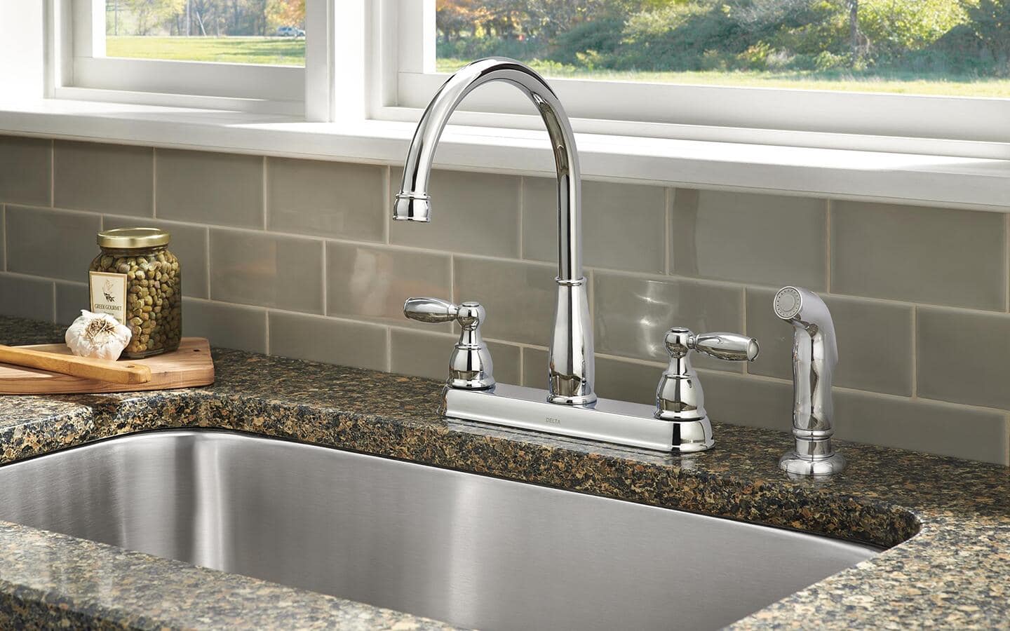 A stainless steel faucet and sprayer.