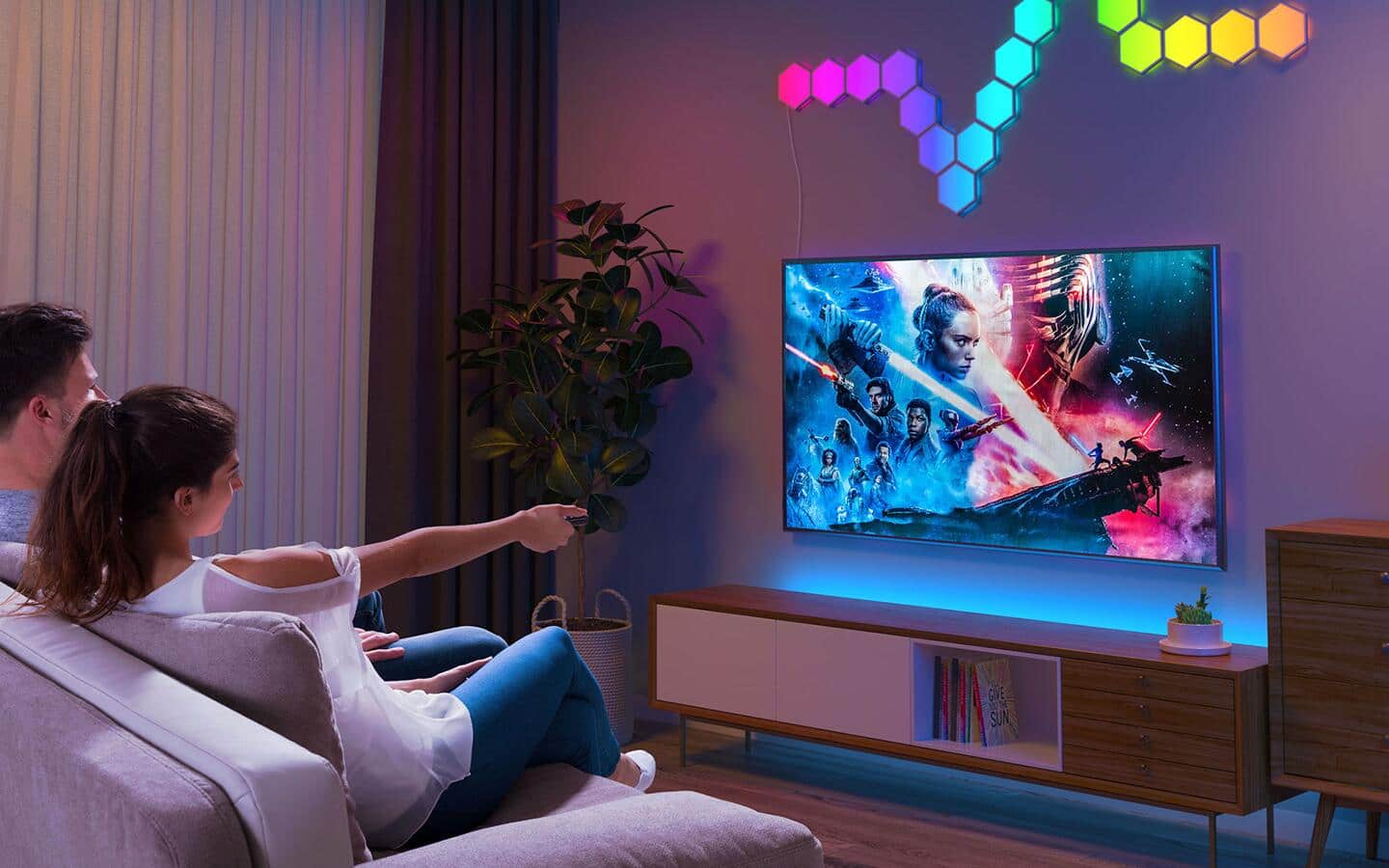 Two people watching a smart TV in a den.