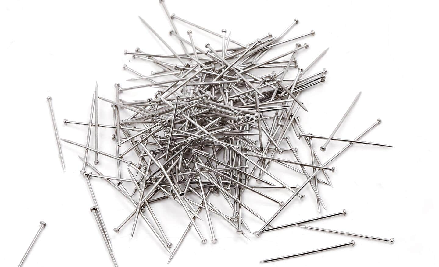 Nails piled on a surface.