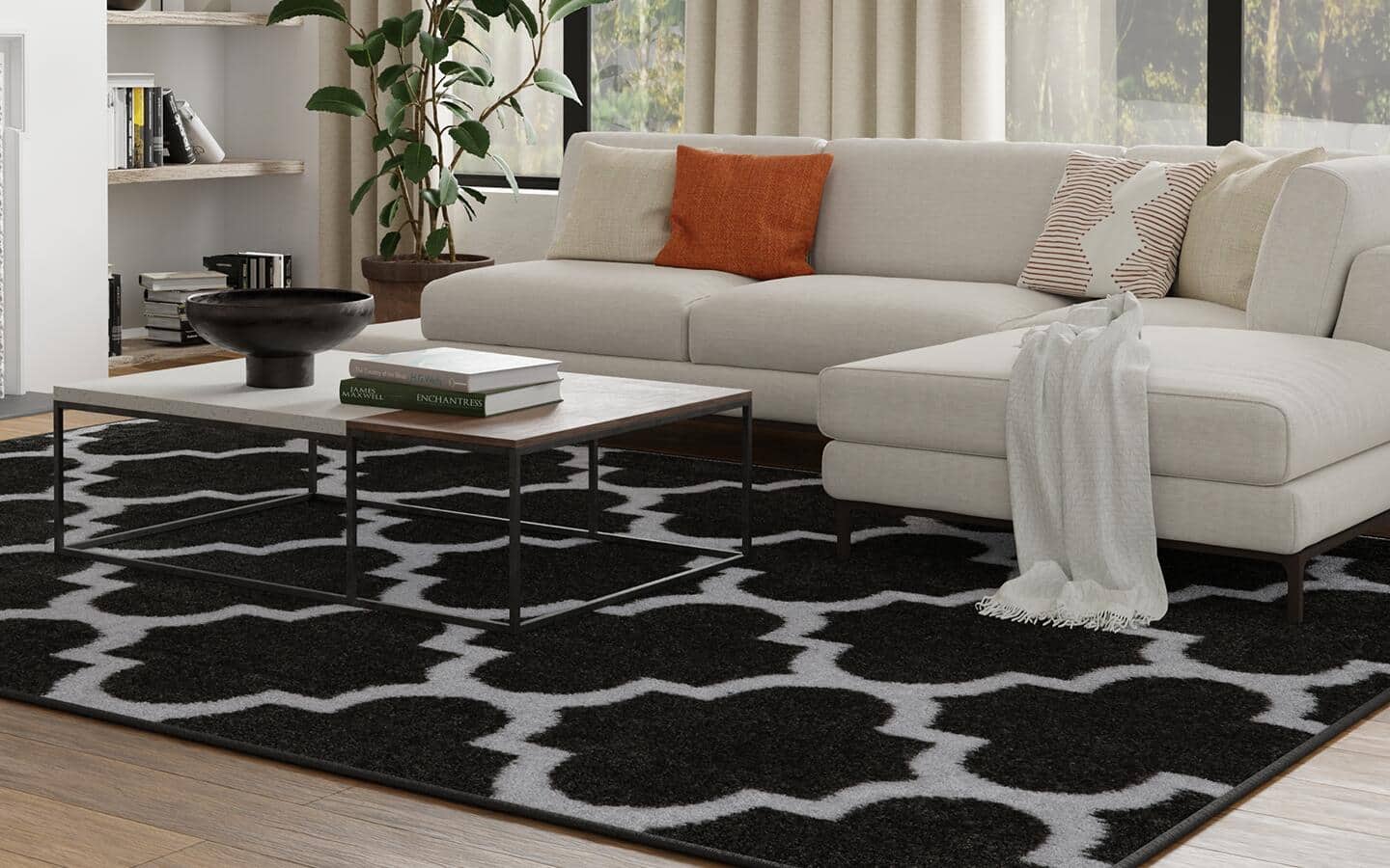 A black and white trellis rug lays on the floor in a living room.