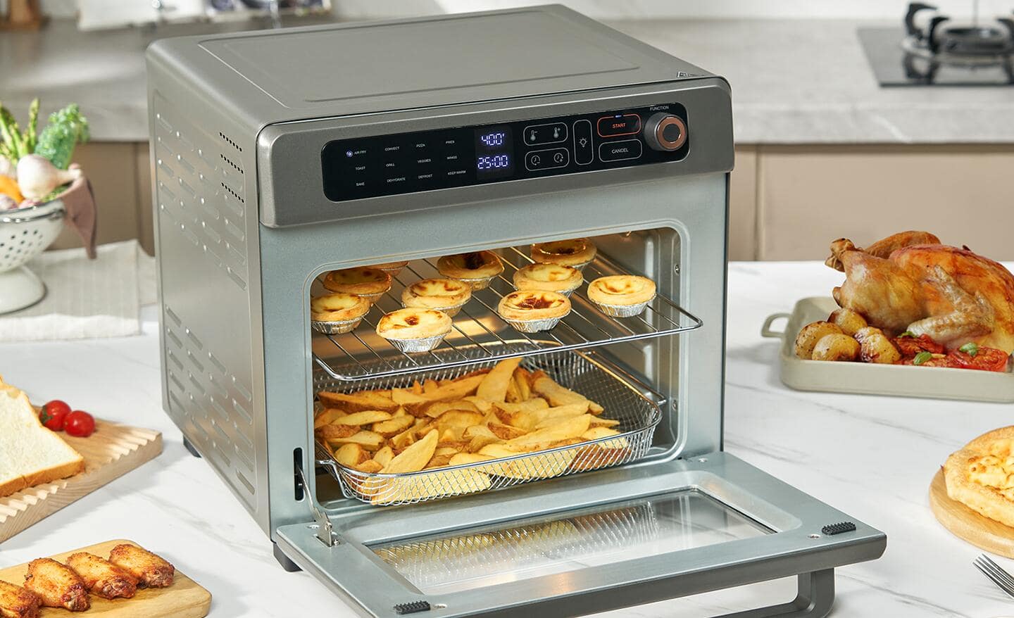 A stainless steel air fryer, toaster oven combination sits open on a counter with food on two racks inside.