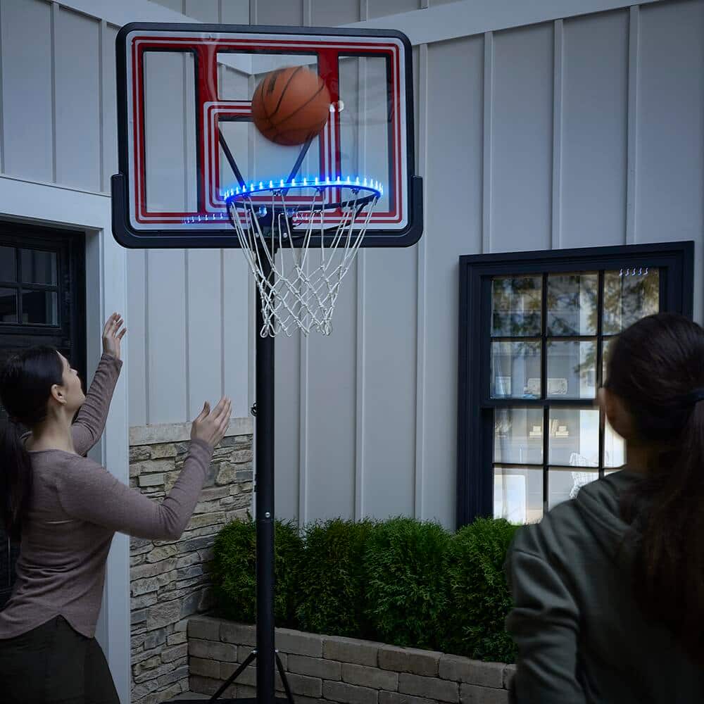 Mom and daughter playing basketball in their driveway.