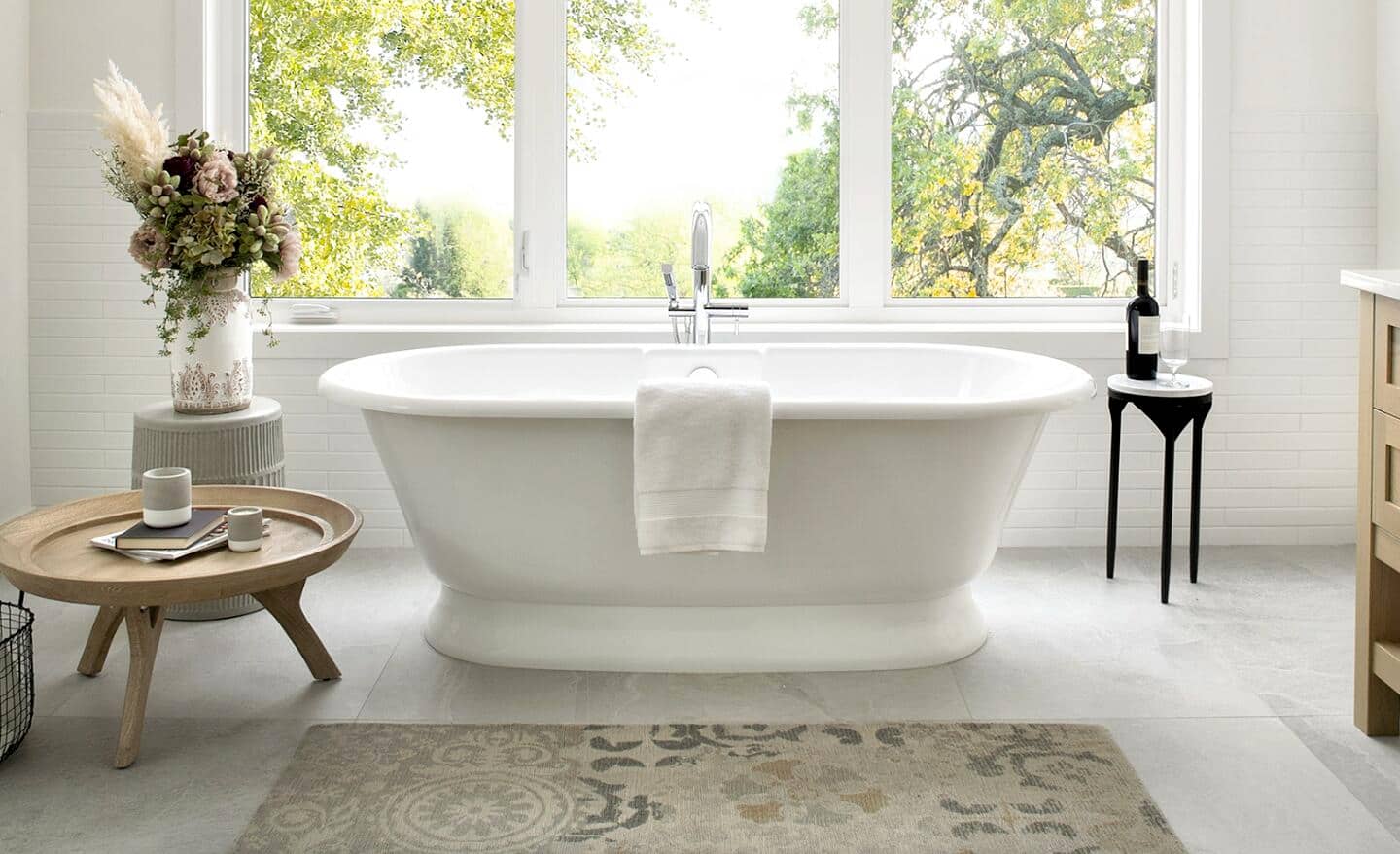 A vintage-style bath rug placed in front of a white bathtub.