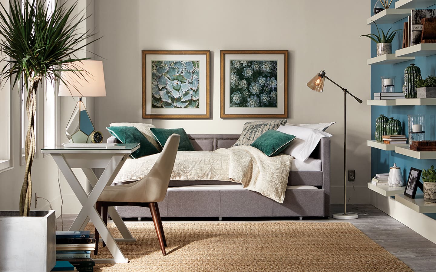 A daybed and desk in a multipurpose room