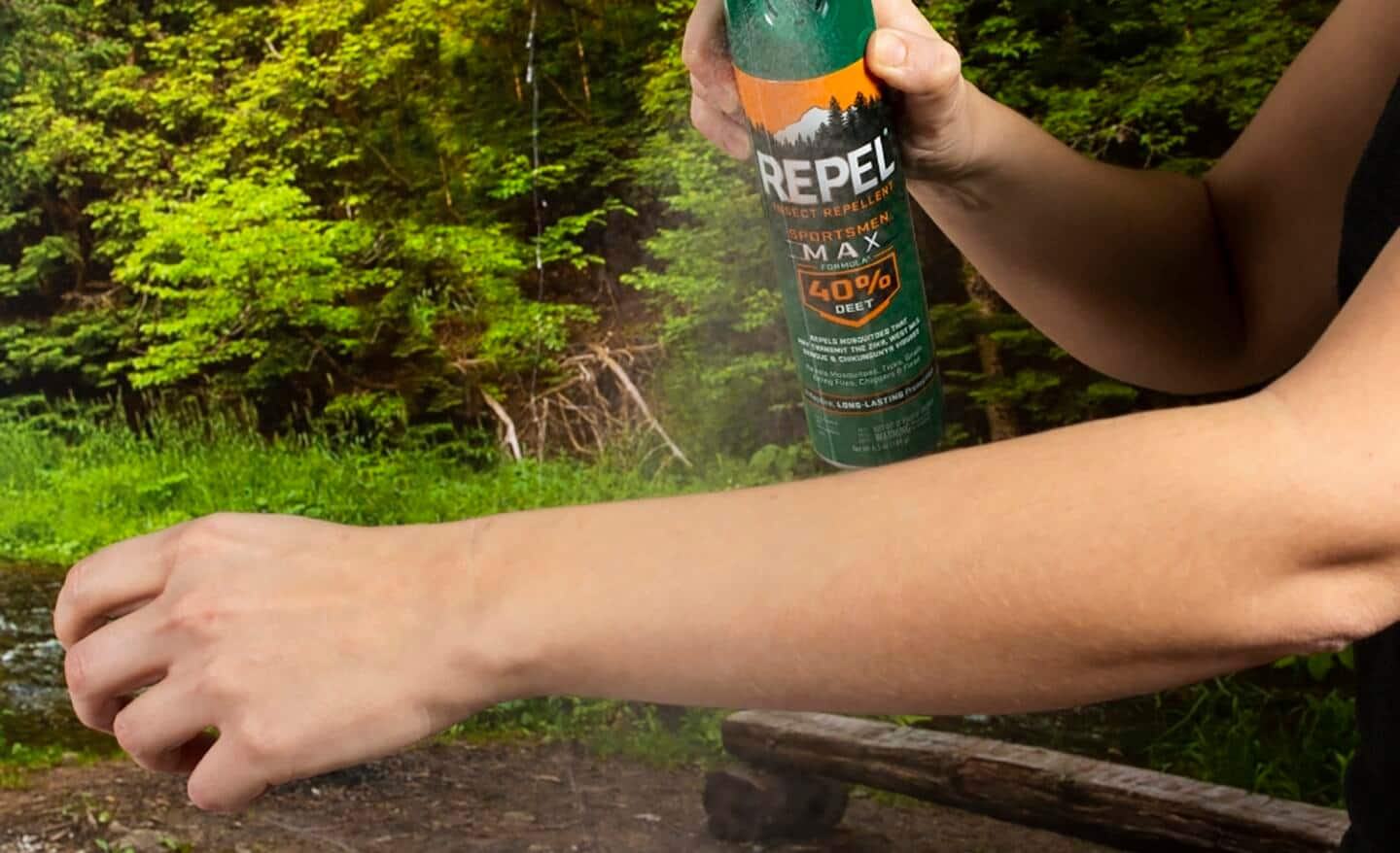 Person sprays mosquito repellent on their arm