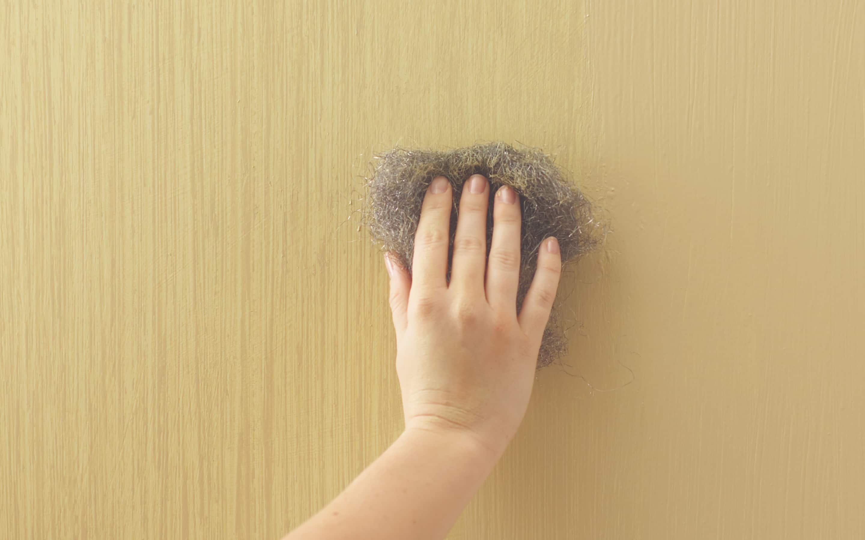 A person painting a wall with the raw silk technique. A person painting a wall with the raw silk technique.