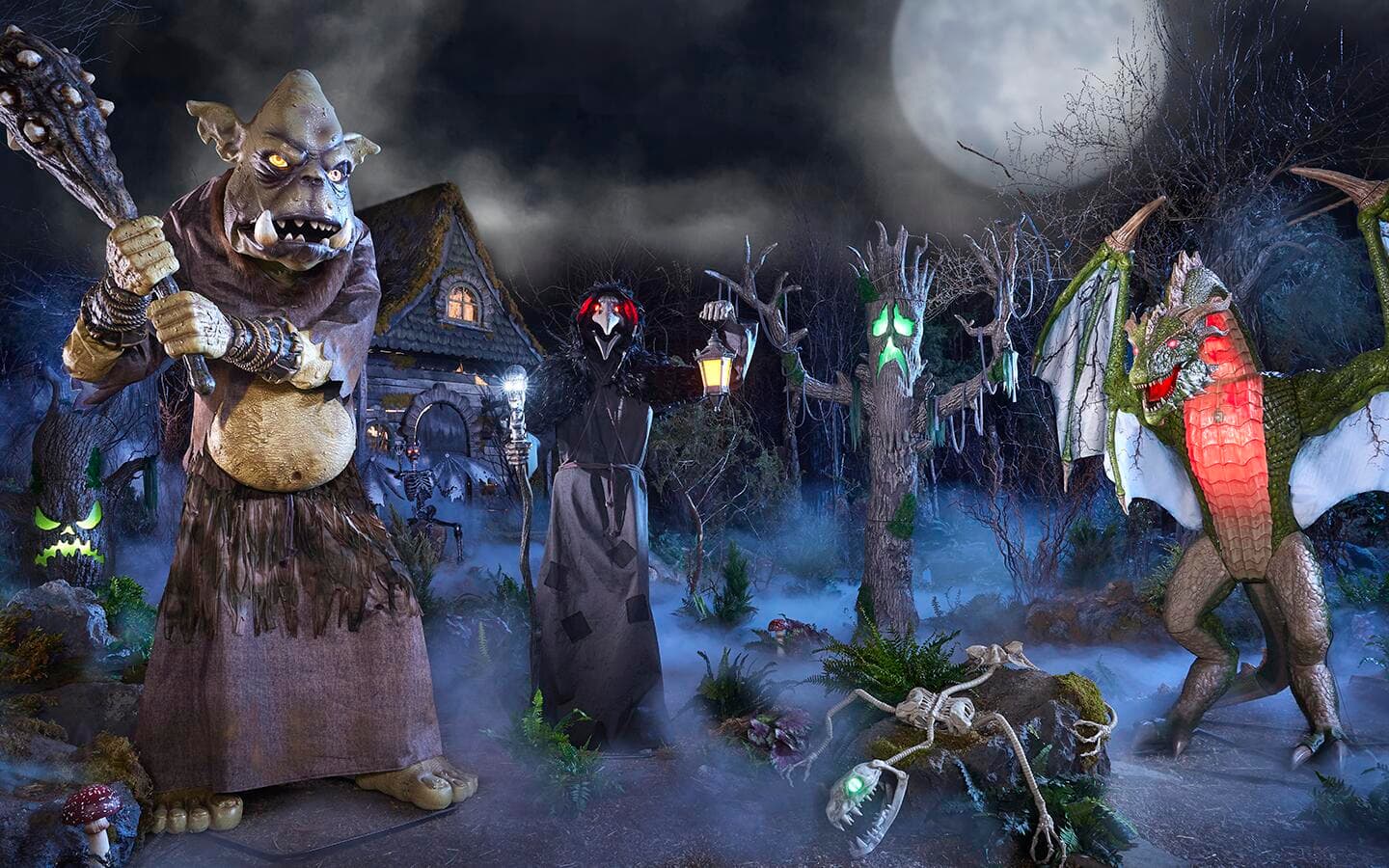 A giant goblin, haunted trees and other creatures in a yard decorated for Halloween.