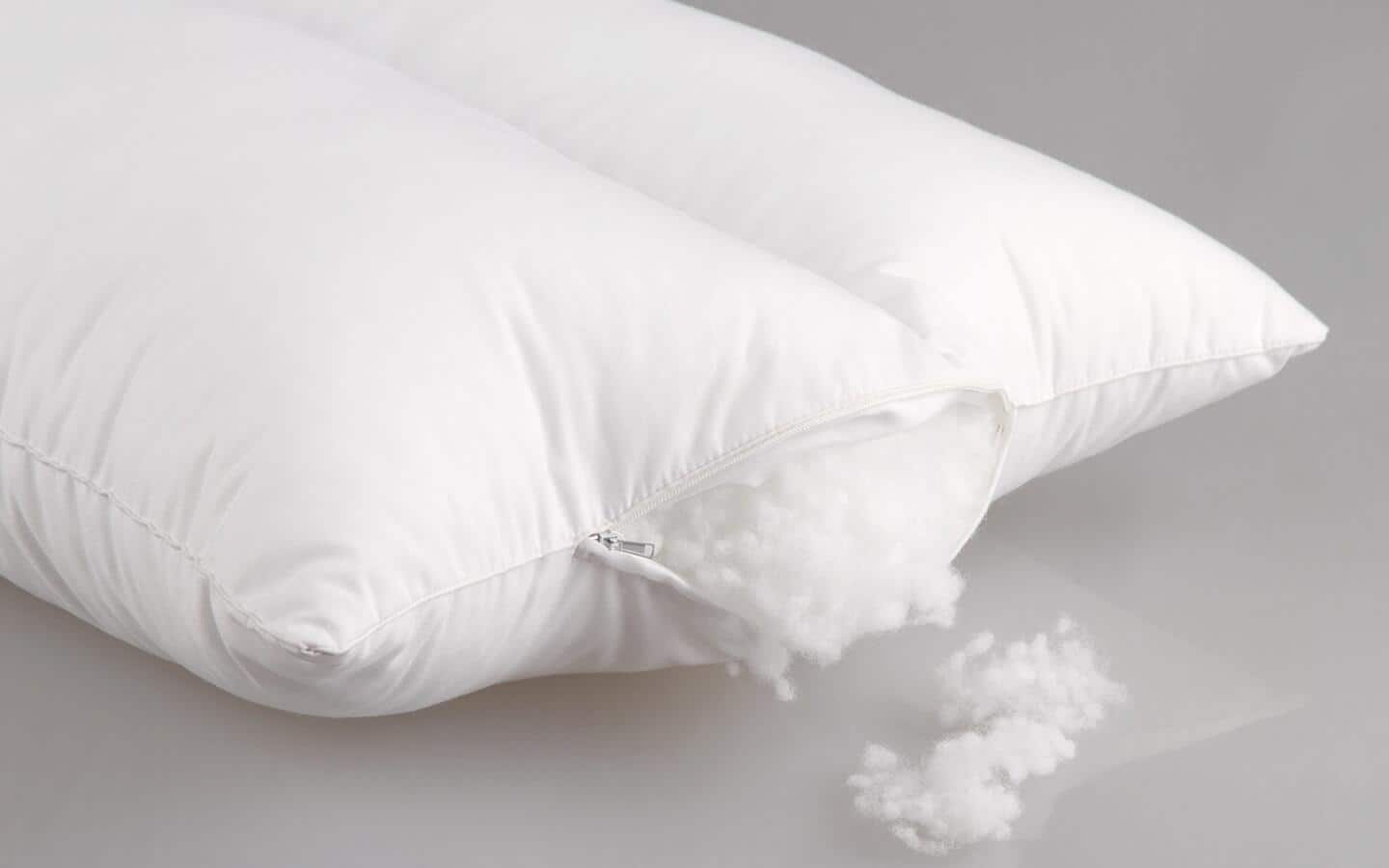 Wool fill spilling out of a pillow. Wool fill spilling out of a pillow.