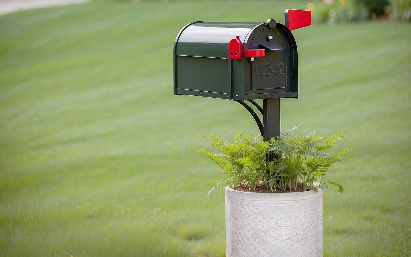 A curbside mailbox installed in a planter with plants. A curbside mailbox installed in a planter with plants.