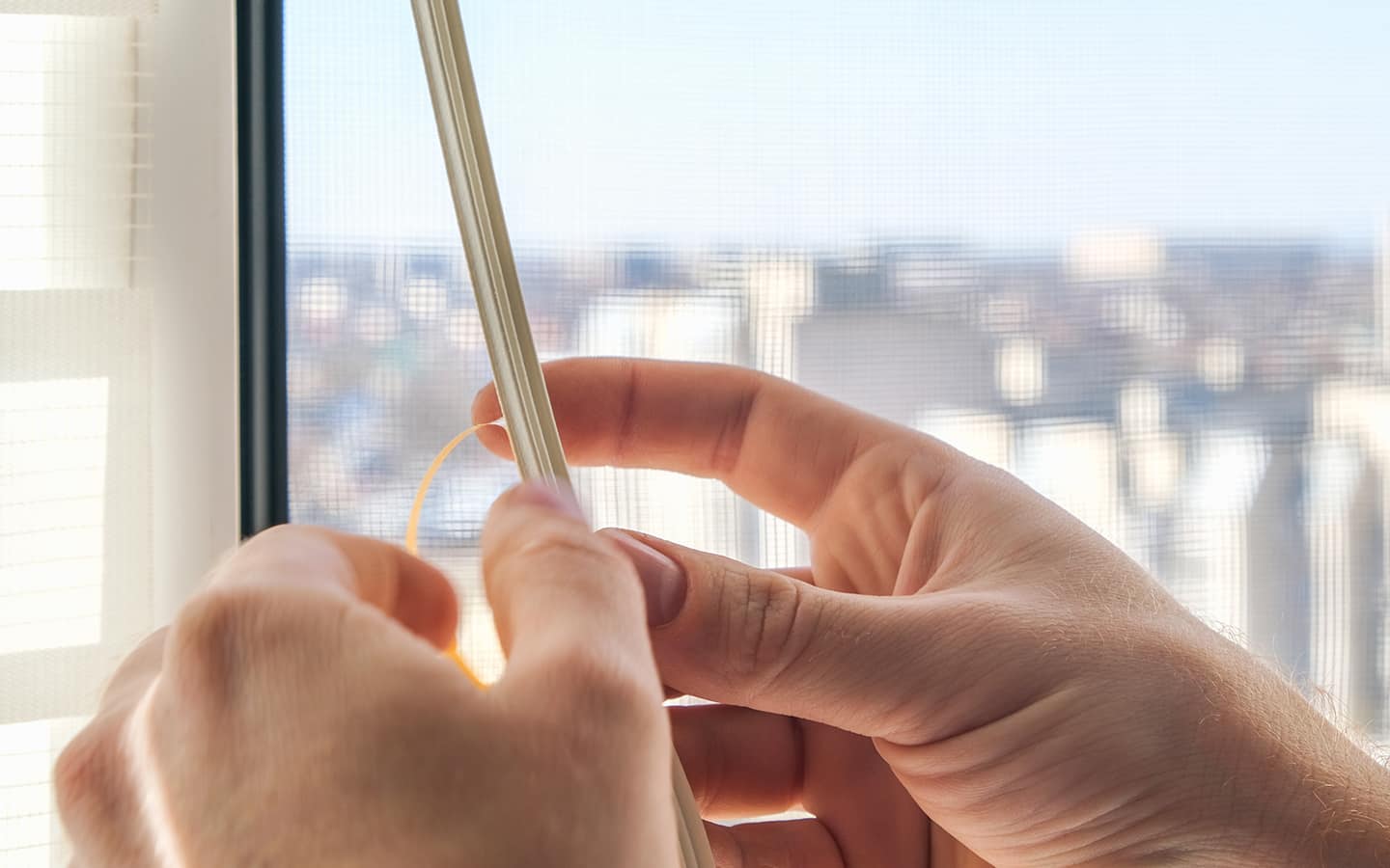 Person applies vinyl to a window sill.