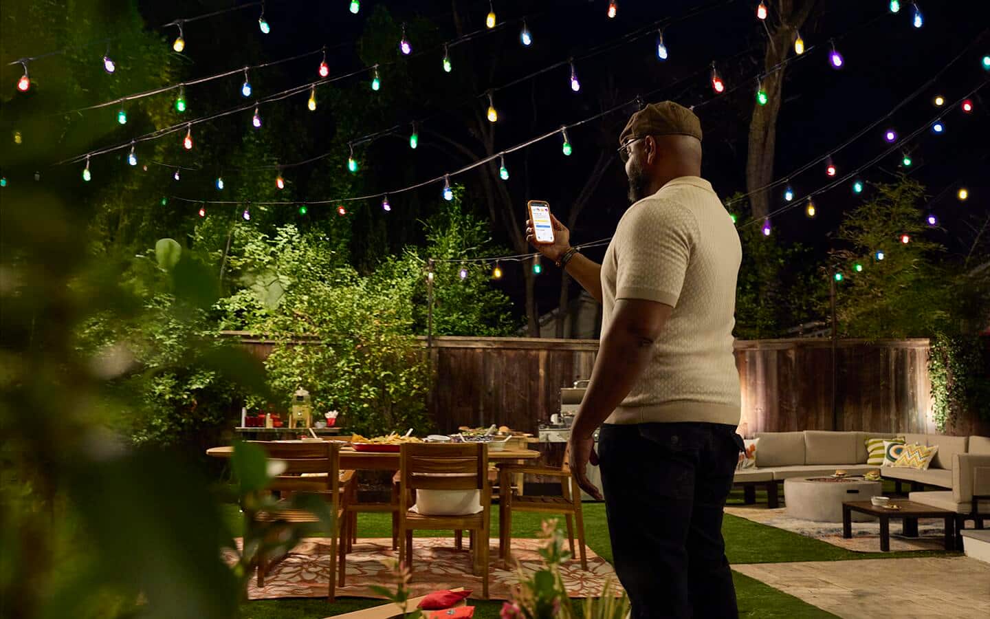 A person controlling outdoor decorative lights with an app.