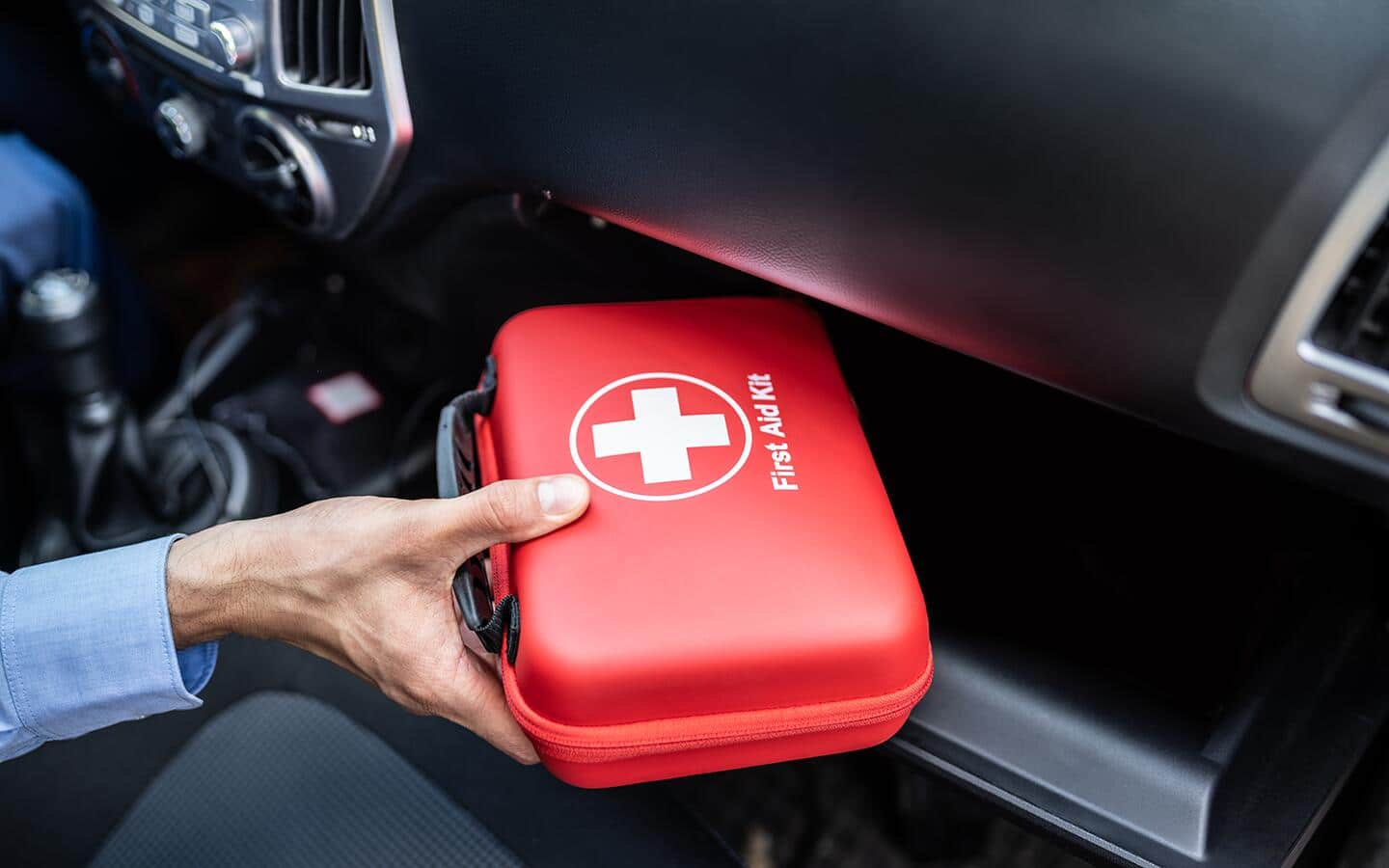 A first aid kit in a car glove box. A first aid kit in a car glove box.