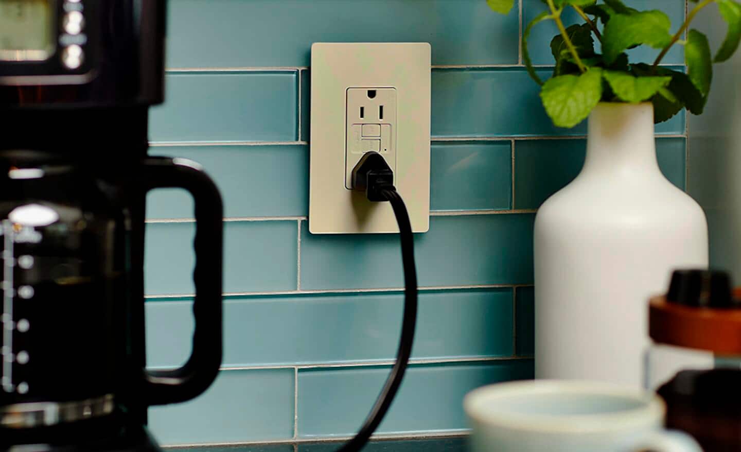 A kitchen appliance plugged into a GFCI outlet.