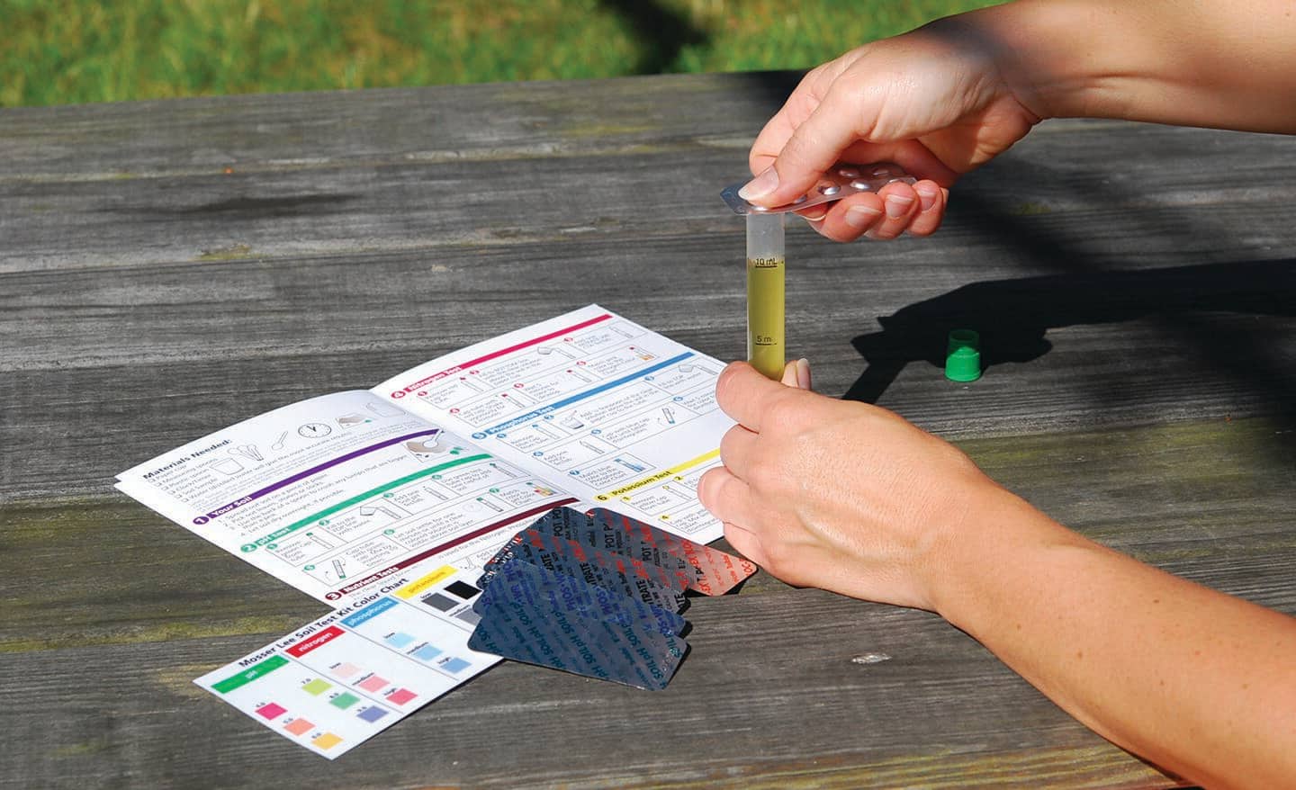 Person using a soil test kit Person using a soil test kit