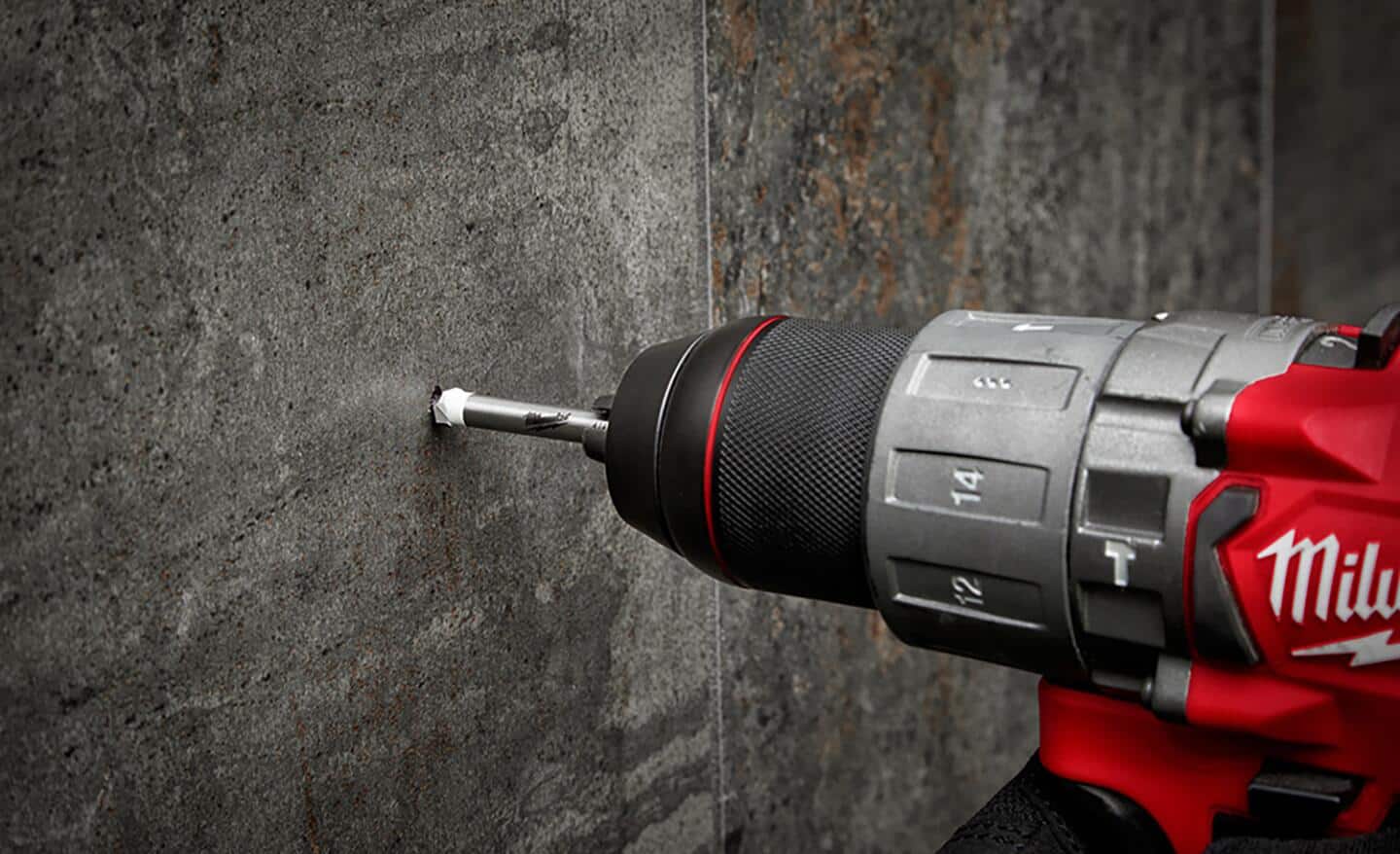 A red drill with a tile drill bit.