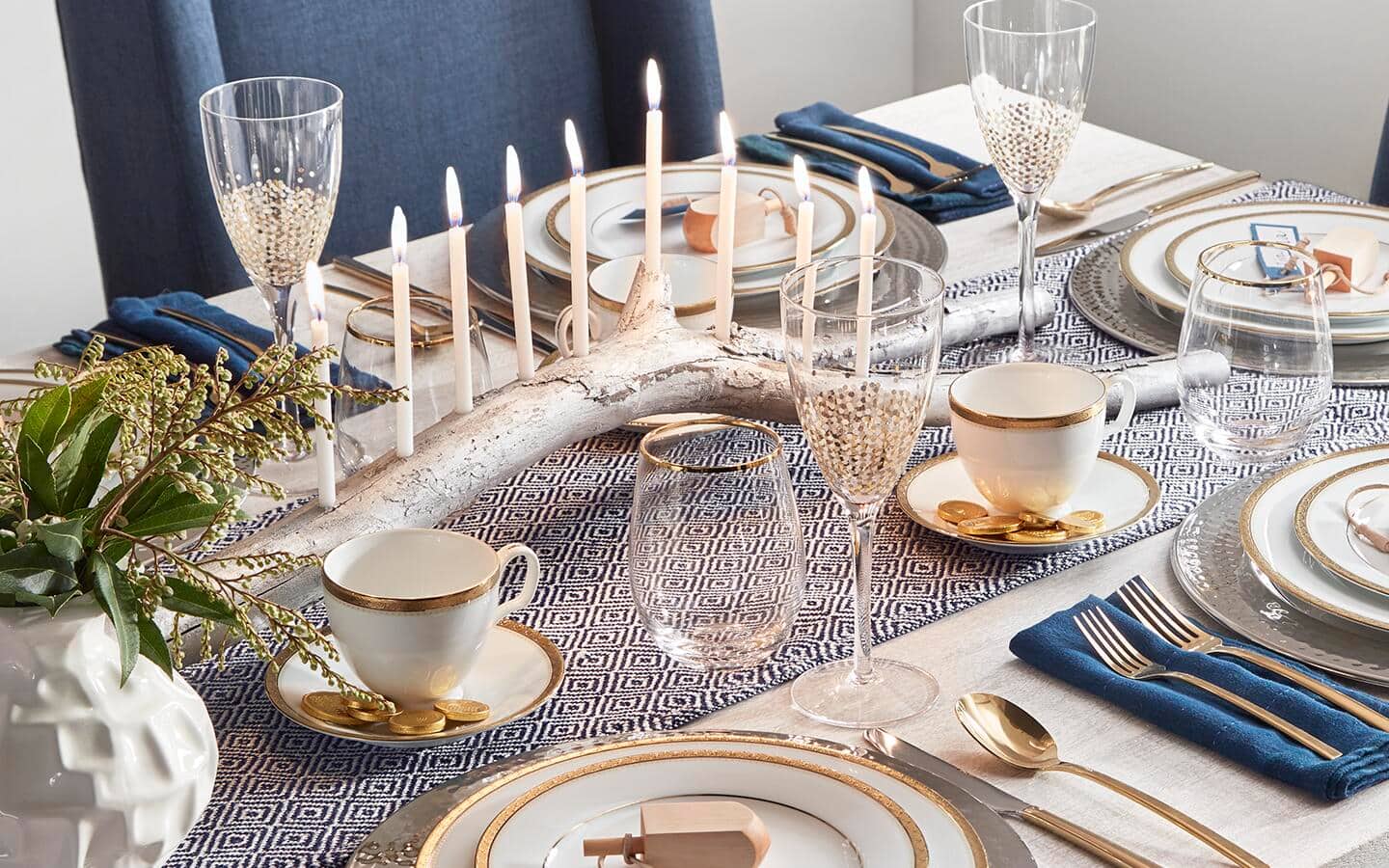 A DIY tree branch menorah used as a table centerpiece.