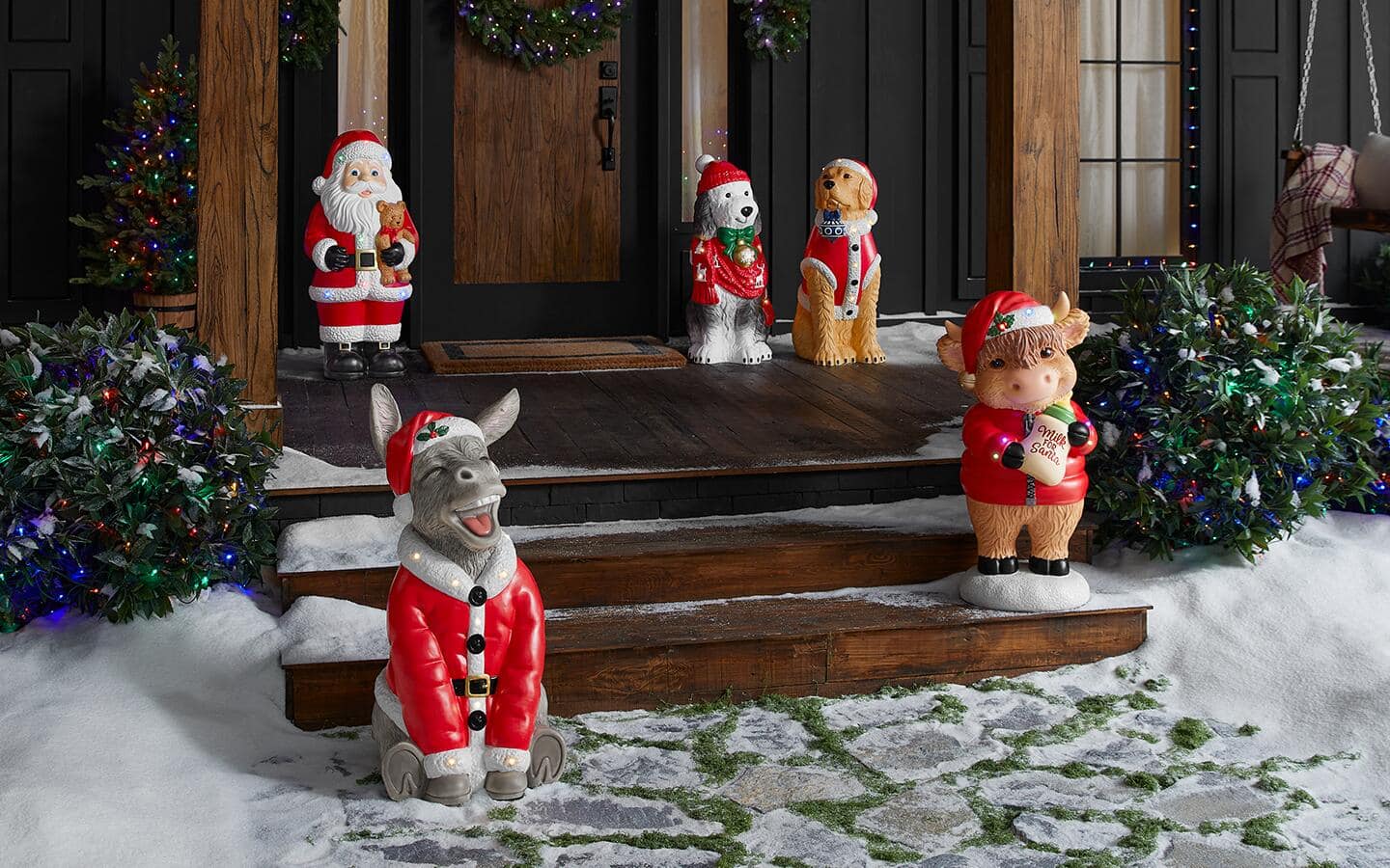 Whimsical reindeer, dogs and other animal-themed holiday statues on a front porch covered with snow. Whimsical reindeer, dogs and other animal-themed holiday statues on a front porch covered with snow.