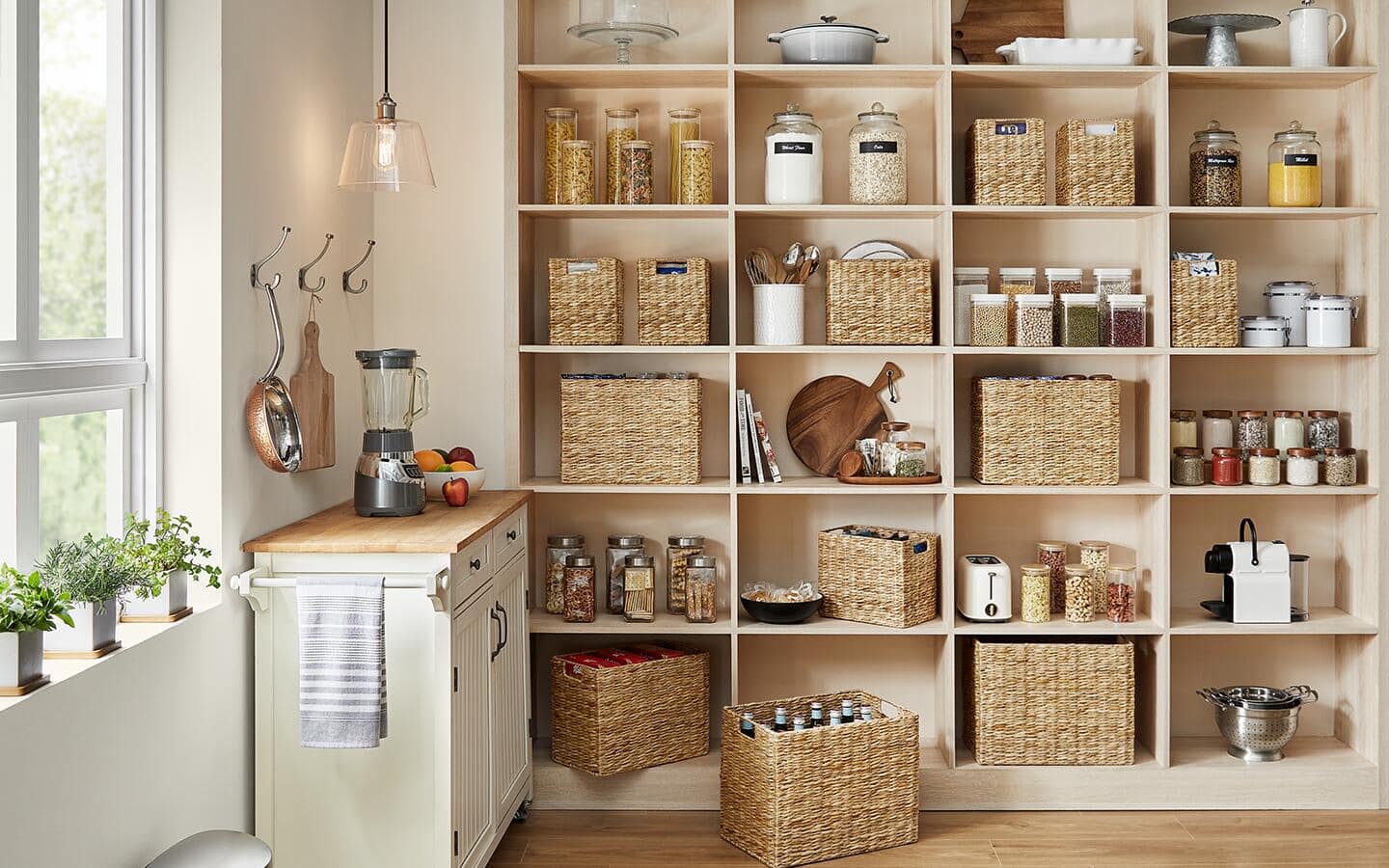 A pantry organized with different baskets, shelves and other organizers.