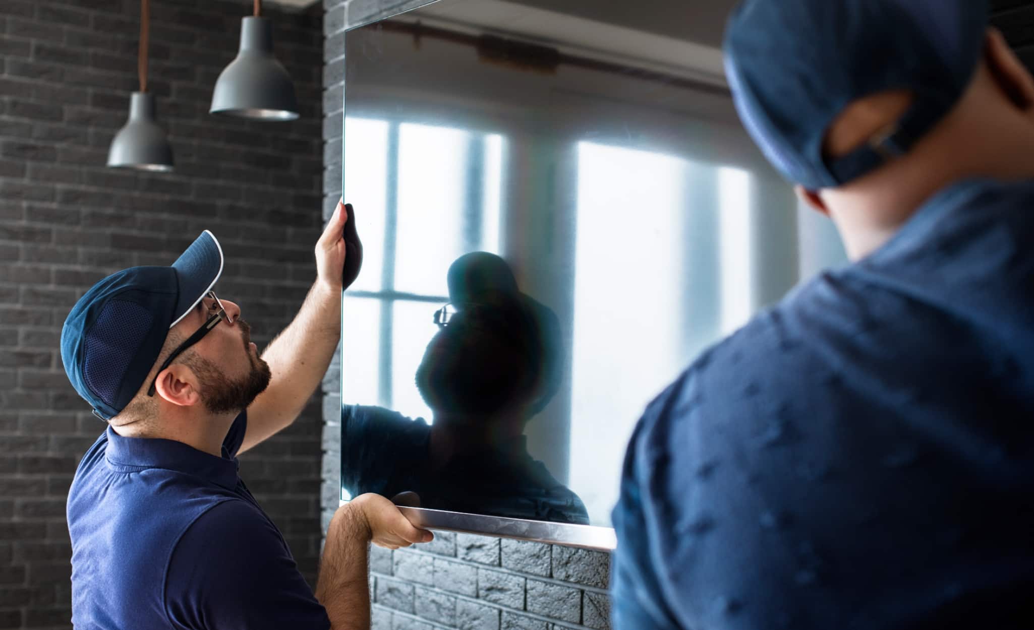 Two Pros install a widescreen TV.