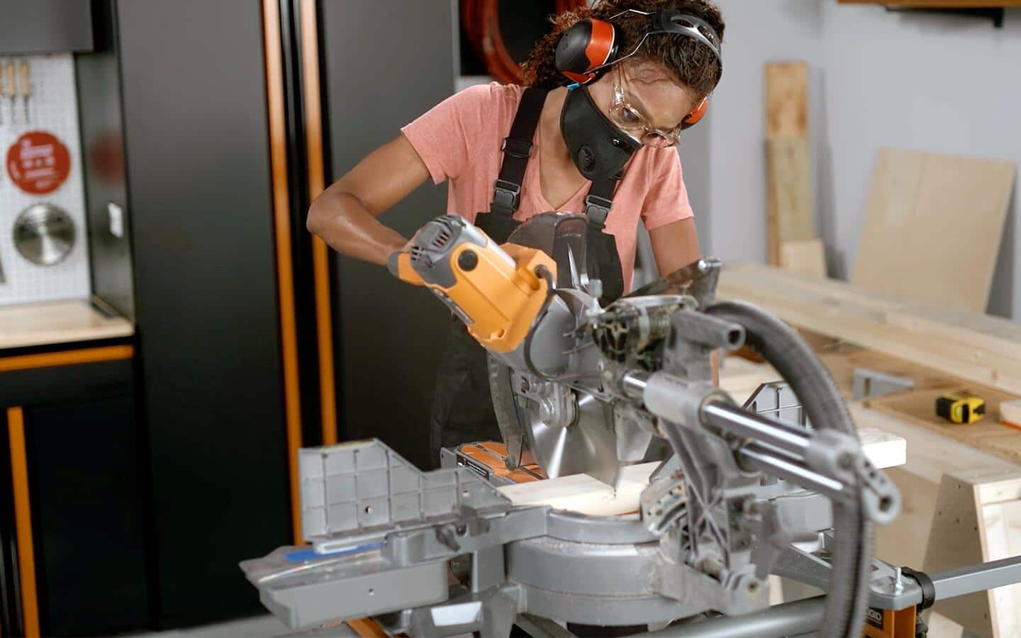 Someone cutting wood to make a cornhole board game. Someone cutting wood to make a cornhole board game.